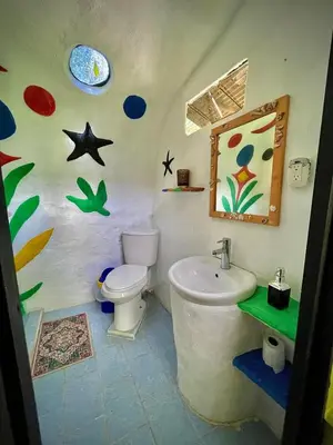 a bathroom with a toilet and a sink at green house in Rivas