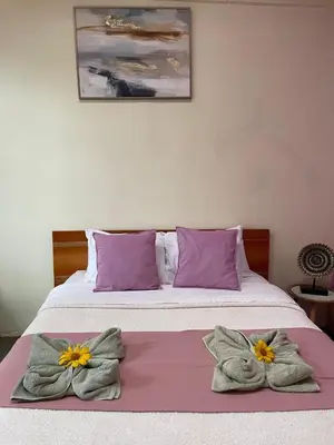 a bedroom with a bed with two towels on it at Zen Mountain Escape 3BR Getaway near Chirripó in Rivas