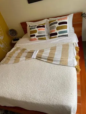 a bed with white sheets and pillows on it at Zen Mountain Escape 3BR Getaway near Chirripó in Rivas