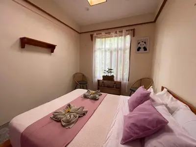 a bedroom with a bed with flowers on it at Zen Mountain Escape 3BR Getaway near Chirripó in Rivas