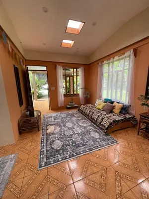 a bedroom with a bed and a large rug at Zen Mountain Escape 3BR Getaway near Chirripó in Rivas