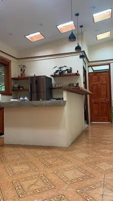 a kitchen with a counter top and a refrigerator at Zen Mountain Escape 3BR Getaway near Chirripó in Rivas