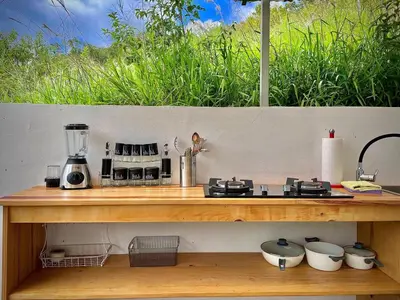 a wooden counter top with a blender on it at House on the Hill 1BR Costa Rica Jungle Escape in Rivas