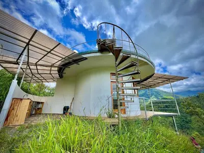 a house with a spiral staircase on the side of it at House on the Hill 1BR Costa Rica Jungle Escape in Rivas