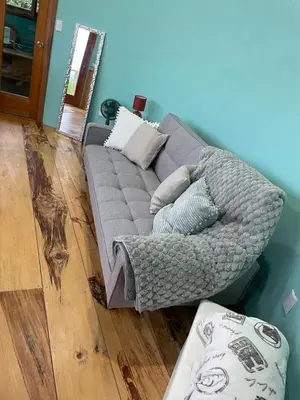 a gray couch sitting in a living room at House on the Hill 1BR Costa Rica Jungle Escape in Rivas