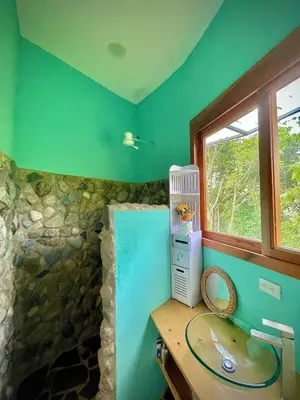 a bathroom with a counter with a sink and a window at House on the Hill 1BR Costa Rica Jungle Escape in Rivas