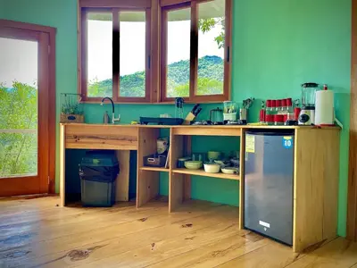 a kitchen with a counter and a sink and some windows at House on the Hill 1BR Costa Rica Jungle Escape in Rivas