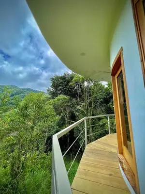 a balcony of a house with an open door at House on the Hill 1BR Costa Rica Jungle Escape in Rivas