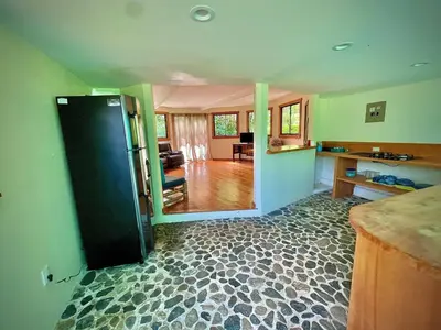 a kitchen and living room with a black door at Dome #1 in Rivas