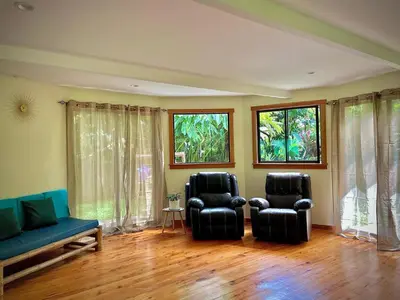 two chairs and a couch in a room with windows at Dome #1 in Rivas