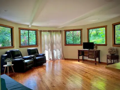 a living room with a couch and a desk and windows at Dome #1 in Rivas
