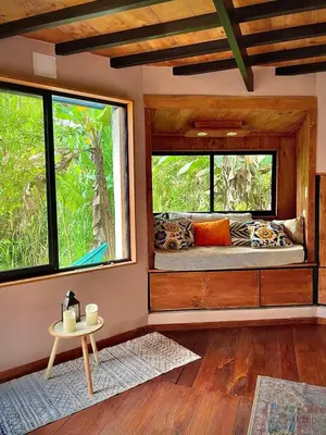 a room with a bed with two windows and a table at Dome 2 in Rivas