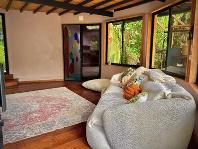 a living room with a couch and some windows at Dome 2 in Rivas