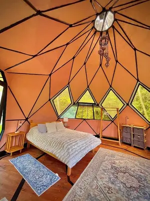 a bedroom with a bed in a room with a window at Dome 2 in Rivas