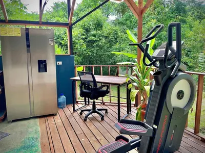 a deck with a table and a chair and a treadmill at Dome 2 in Rivas