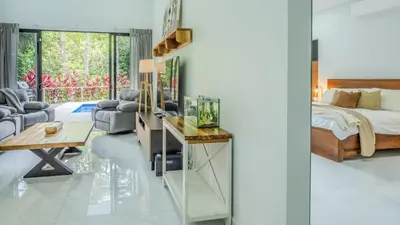 a bedroom with a bed and a desk and a bed and a bed at Modern Retreat in the Rainforest with River Access in Ojochal