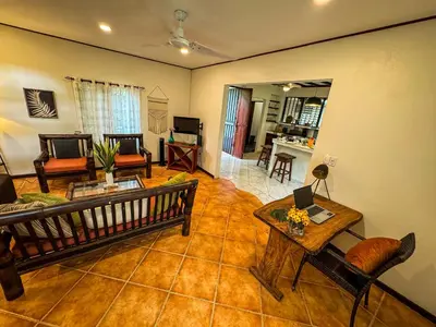 a living room with a couch and a table at Rustic Tropical Retreat with Pool & Garden Ojochal in Ojochal