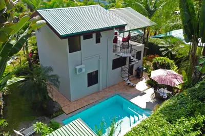 an aerial view of a house with a swimming pool at Rustic Tropical Retreat with Pool & Garden Ojochal in Ojochal