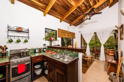 a kitchen with a stove and a sink at Casa Rustica 1 in Playa Grande