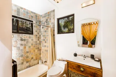 a bathroom with a sink and a toilet and a tub at Casa Rustica 1 in Playa Grande