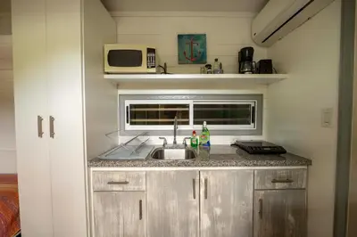 a kitchen with a sink and a microwave at Casa Playa Avellanas in Playa Avellana