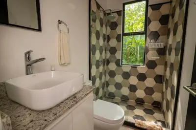 a bathroom with a sink and a toilet and a shower at Casa Playa Avellanas in Playa Avellana