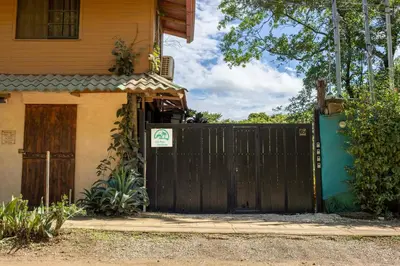 a black gate in front of a house at Casa Playa Avellanas in Playa Avellana