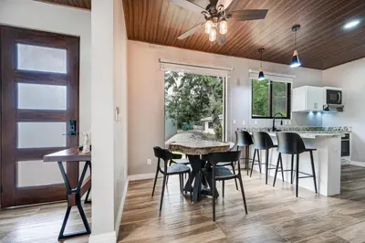 a dining room and kitchen with a table and chairs at Montedonato 18 - Combo in Playa Avellana