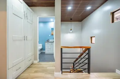 a kitchen with white cabinets and a wooden ceiling at Montedonato 18 - Combo in Playa Avellana