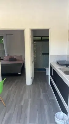 a room with a bedroom with a bed and a kitchen at Villas del sol in Uvita