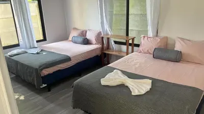 a room with two beds with towels on the floor at Villas del sol in Uvita
