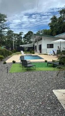 a bench sitting in front of a house at Villas del sol in Uvita