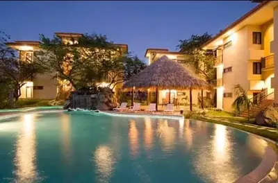 a swimming pool in front of a building at 2 beds -2 baths condos near Tamarindo Beach in Tamarindo