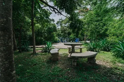 a picnic table and two benches in a park at 2 beds -2 baths condos near Tamarindo Beach in Tamarindo