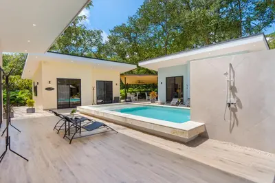 a swimming pool in the backyard of a house at Le MaGil Boutique Hotel in Tamarindo