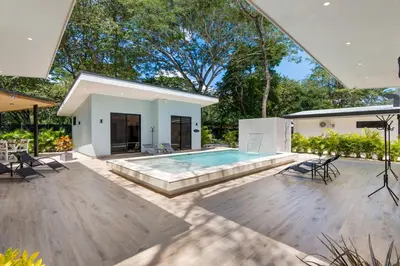 a backyard with a pool and a house at Le MaGil Boutique Hotel in Tamarindo