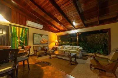 a living room with a couch and a table at Casa Cres, Beachfront, Private Pools, Tennis and AC! in El Roble