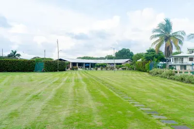 a large grass field in front of a building at Casa Cres, Beachfront, Private Pools, Tennis and AC! in El Roble