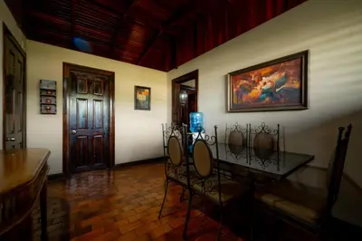 a room with a table and chairs and a door at Casa Cres, Beachfront, Private Pools, Tennis and AC! in El Roble