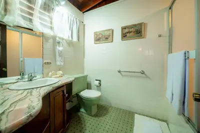 a bathroom with a toilet and a sink at Casa Cres, Beachfront, Private Pools, Tennis and AC! in El Roble