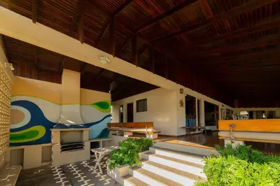 a room with stairs and tables and a building at Casa Cres, Beachfront, Private Pools, Tennis and AC! in El Roble