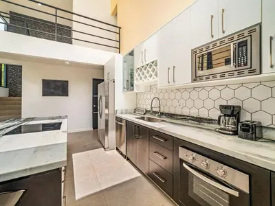 a large kitchen with stainless steel appliances and cabinets at The Wave House in Santa Cruz