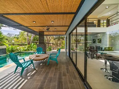 an indoor patio with a table and chairs and a pool at The Wave House in Santa Cruz