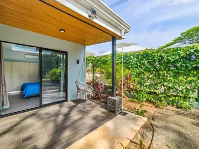 a house with a patio with a view of a garden at The Wave House in Santa Cruz