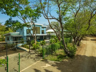 a blue house with a fence in front of it at The Wave House in Santa Cruz