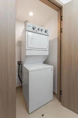 a white washer and dryer in a kitchen at Casa Brisa Tranquila, Pools, Gym, & Beach Club in Sardinal