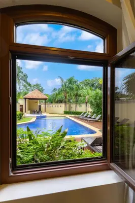 a window with a view of a swimming pool at Stunning Remodeled Beachfront Condo! in Tamarindo