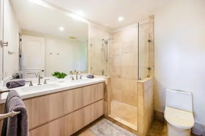 a bathroom with a shower and a sink and a toilet at Stunning Remodeled Beachfront Condo! in Tamarindo