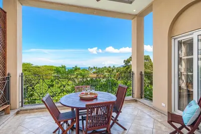 a patio with a table and chairs on a balcony at Beautiful Ocean View Condo Steps to the Beach in Tamarindo