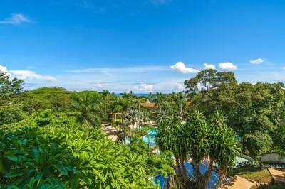 an aerial view of a resort with trees and a pool at Beautiful Ocean View Condo Steps to the Beach in Tamarindo